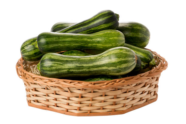 zucchinis in wicker basket on isolated white background zucchinis in wicker basket on isolated white background. phallus shaped stock pictures, royalty-free photos & images