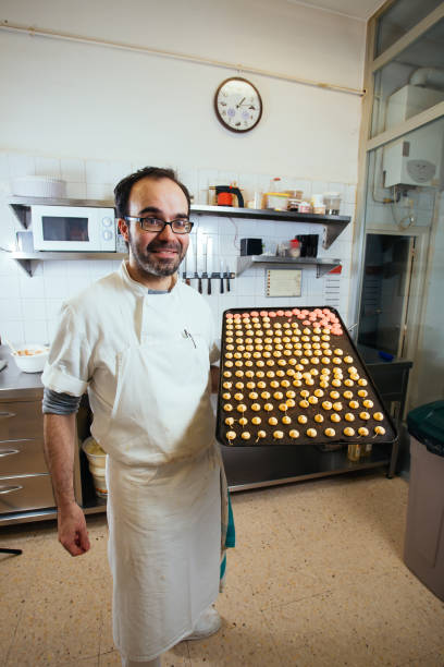 istock Pastress showing tray of cakes 1316822833