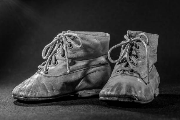 istock Old and worn childrens leather shoes 1316823355