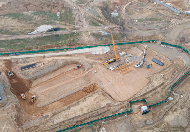 istock Vibration road roller and wheel loader leveling ground for construct of foundation. Soil Compactor compresses soil under the formwork 1316823966