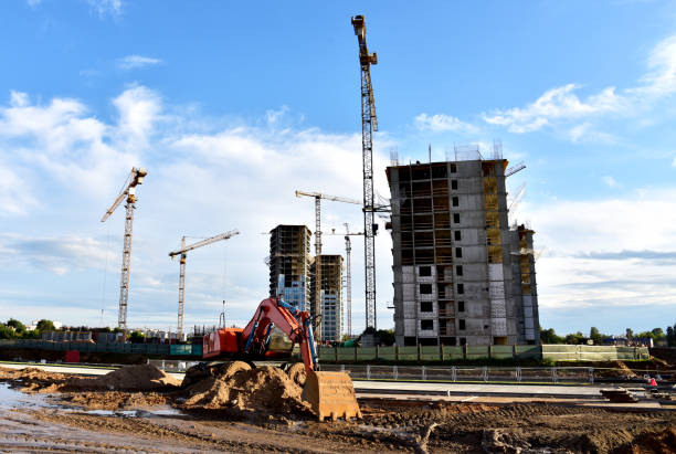 istock Excavator on earthmorks at construction site. Backhoe dig ground for the construction of foundation and laying sewer pipes district heating 1316823997
