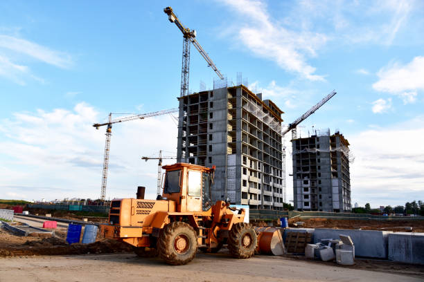 istock Wheel loader with a bucket at construction. Heavy machinery for loading and unloading works and road work. Public works, civil engineering, road construction 1316824010