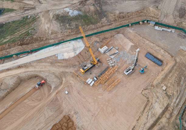 istock Vibration road roller and wheel loader leveling ground for construct of foundation. Soil Compactor compresses soil under the formwork 1316825362
