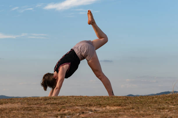 istock woman exercising outdoor alone with blue sky 1316830557