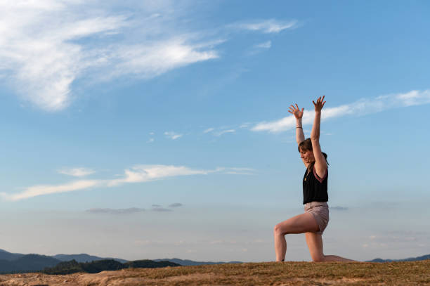 istock woman exercising outdoor alone with blue sky 1316830559