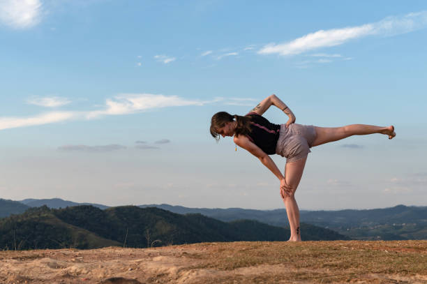 istock woman exercising outdoor alone with blue sky 1316830601