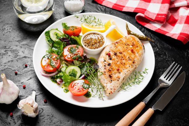 istock Grilled chicken breast with fresh vegetable salad. 1316833054