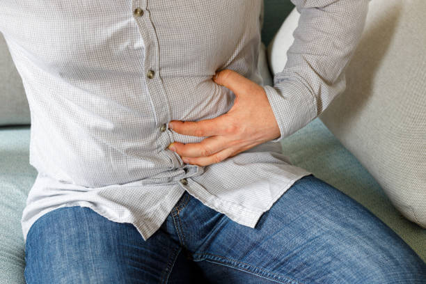 istock a man in a shirt feeling pain for a aching stomach around the appendix 1316833820