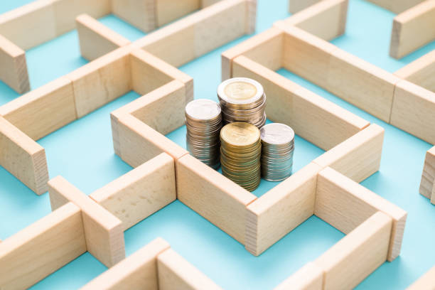 Find a way to the money Group of coins heaps in the maze game built by wood blocks, find a way to money resource, business budget, making money concept currency chasing discovery making money stock pictures, royalty-free photos & images