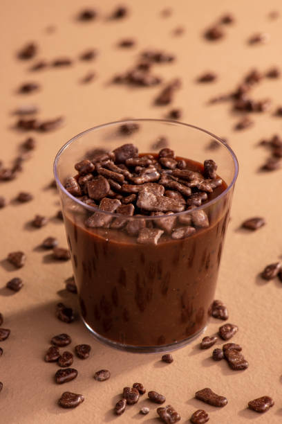 istock acrylic cup with brigadeiro and chocolate sprinkles on brown background 1316835471