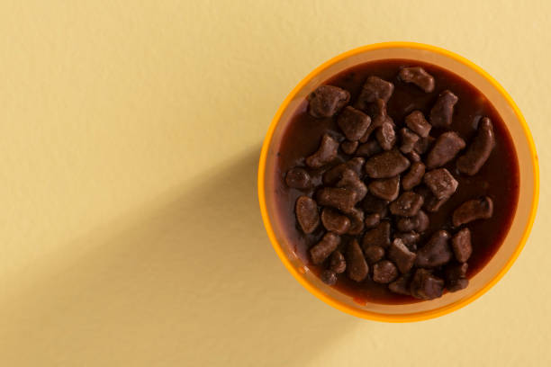 istock acrylic cup with brigadeiro and chocolate sprinkles on yellow background 1316835490