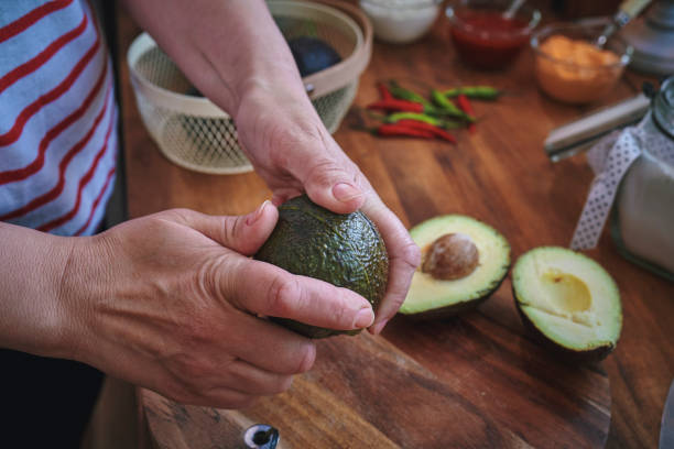 istock Cutting Avocado on Wooden Cutting Board 1316835662