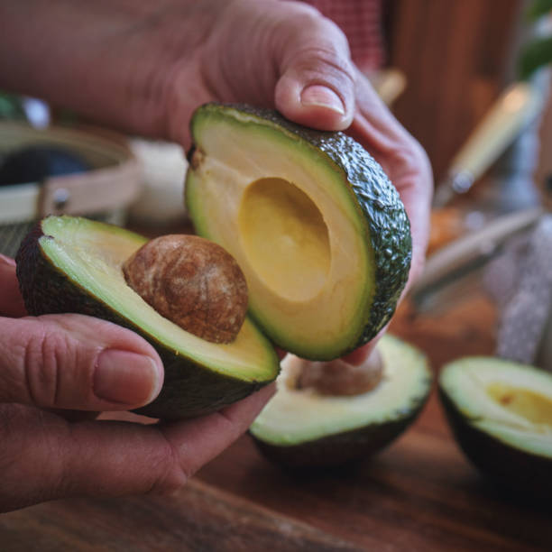 istock Cutting Avocado on Wooden Cutting Board 1316835704