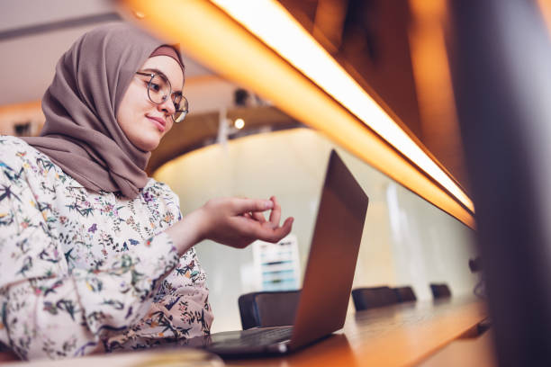 istock Middle Eastern Girl working on a laptop from a luxury hotel lounge 1316836645
