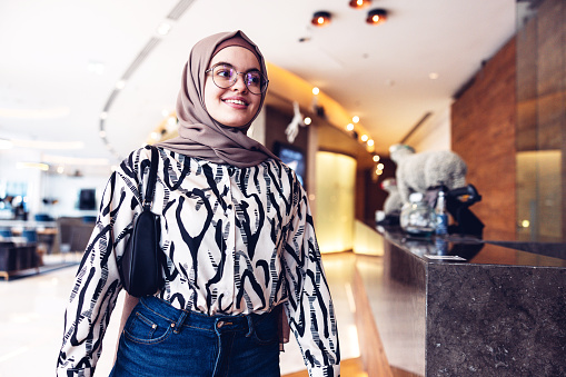 Portrait of a Middle Eastern Young Woman arriving at a luxury hotel