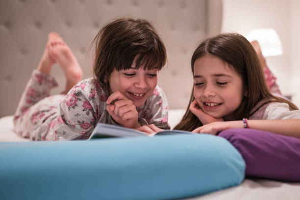 istock Joyful kids reading bedtime stories 1316839283