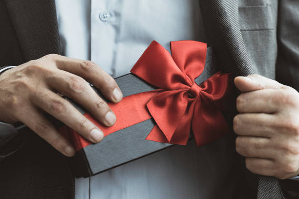 istock Businessman giving Gift Box 1316840191