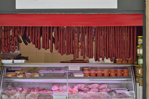 A pitcher’s market in Cádiz, Spain with his display of sausages, chickens and beef