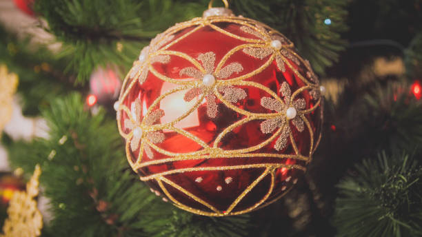 istock Closeup image of red with gold bauble hanging on Christmas tree 1316840773
