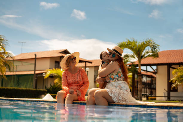 istock Family by the pool hugging the child 1316841618