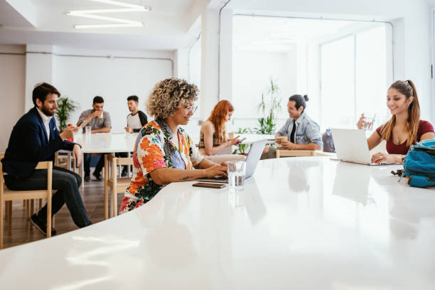 istock Coworkers in office after reopening working on laptops in office 1316843845