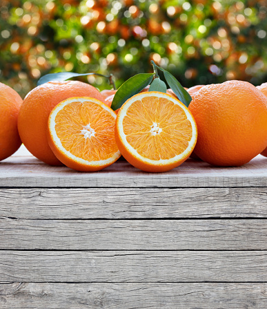Fresh oranges and blank wooden background. Ready to use for your text and design