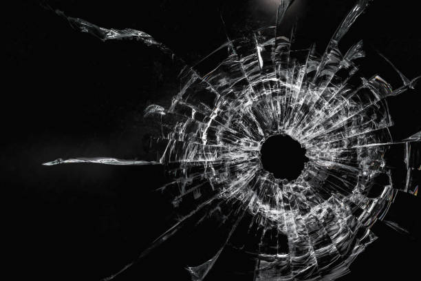 istock Dirty broken glass with a bullet hole on a black background close-up 1316844100