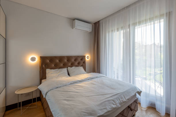 istock Bedroom interior with large windows and curtains 1316849579