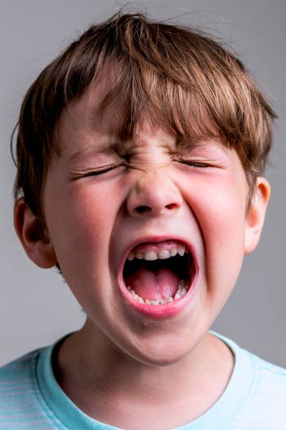 istock Crying caucasian little boy On gray background 1316850797