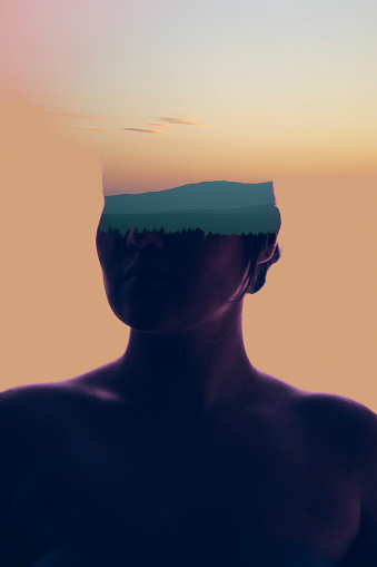 Double exposure of silhouette of women portrait and wide shot of mountains and pine forest after sunset.