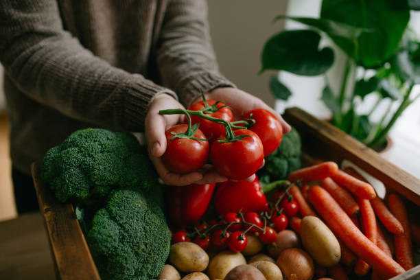istock Male hands holding bunch of tomatoes 1316852653