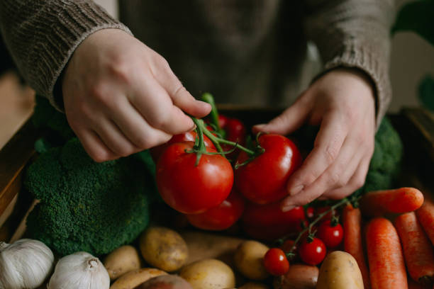 istock Man holding bunch of tomatoes 1316852758