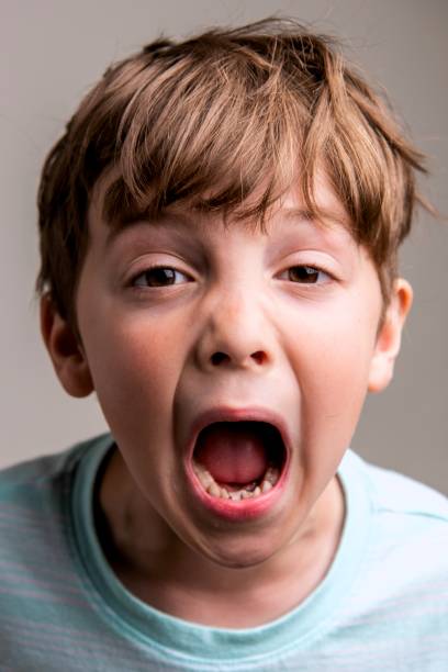 istock Screaming caucasian little boy On gray background 1316853856