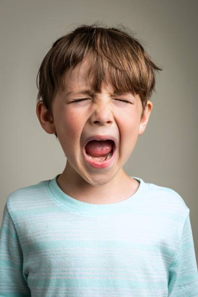 istock Crying caucasian little boy On gray background 1316856241