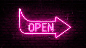 3D rendering of glowing neon arrows with the inscription open on a brick wall background