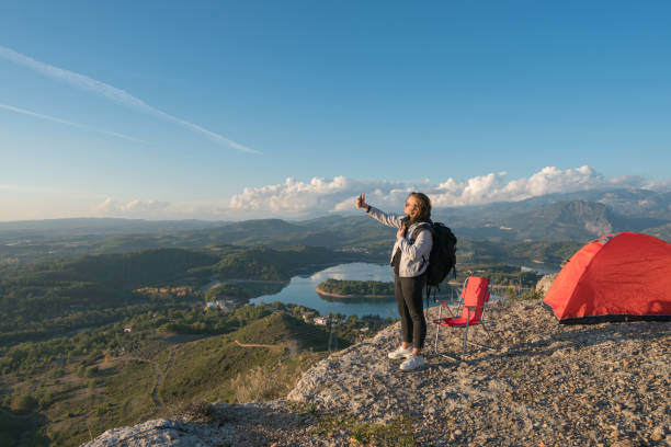 istock Young man doing selfie on the mountain peak 1316859209