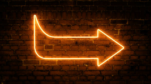 istock 3D rendering of glowing neon arrows on a brick wall background 1316859344