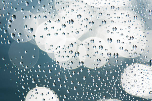 istock Water droplets on glass with blurred soft light bokeh background. Bokeh pattern. Wallpaper. Bokeh background. 1316860497