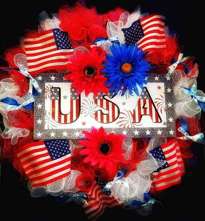 Independence Day USA concept. Memorial Day. Red roses over the USA flag top view flat lay with copy space