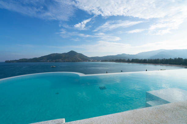 Swimming pool with stair on top of roof deck building looking at view tropical sea ,Luxury beach villa house with sea view swimming pool in modern design,Summer Vacation and travel background concept. piscina con escalera en la parte superior del edificio de la cubierta de la azotea que mira a la vista del mar tropical, casa de villa de playa de lujo con piscina con vistas al mar en diseño moderno, vacaciones de verano y concepto de fondo de viaje
