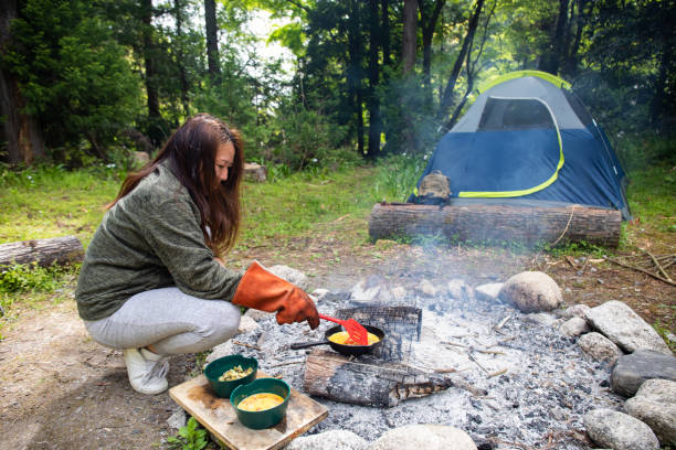 istock A woman camp fire cooking in the wilderness 1316871079