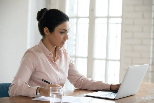 istock Focused young Indian business woman working on computer 1316877984