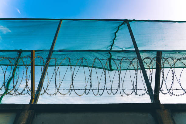 Barbed wire on the fence around an abandoned building