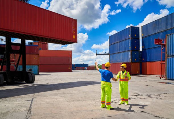 istock foreman are talking for manage box container at shipping site in good clear blue sky for logistics service transportation 1316895841