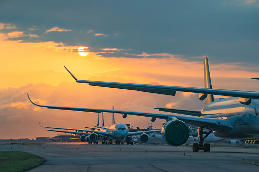 Hong Kong, May 10,2020: Due to Coronavirus Covid-19 airline fleet grounded at the Airport taxiway. The largest Hong Kong based carrier Cathay Pacific Airways grounded most of their aircraft fleet. Those aircrafts lined up at on the taxiway and waiting to transfer to out port for a long term parking.