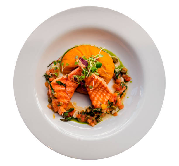 istock Grilled trout fish with mashed sweet potato and orange sauce. White background 1316896685