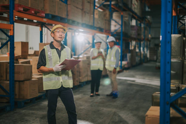 istock asian chinese management having discussion with warehouse worker at warehouse with white hardhat using digital tablet 1316897140