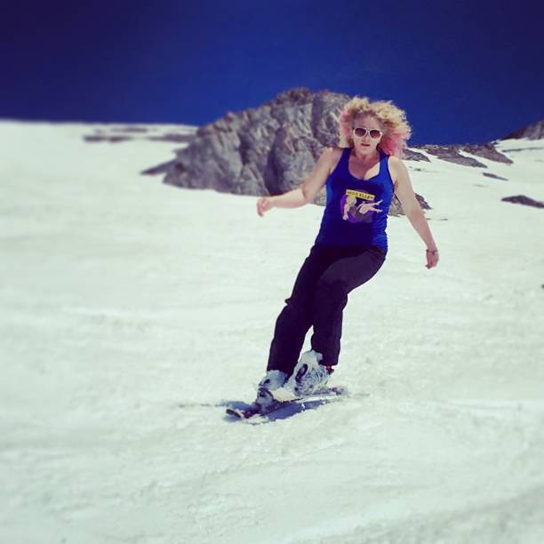 Woman snowblading on a ski run.