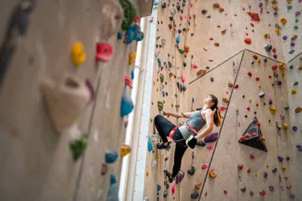 istock Young Sportswoman Reaching into Chalk Bag During Climb 1316903532