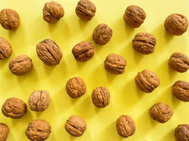 istock Group of Large Walnuts on Yellow Background 1316903807